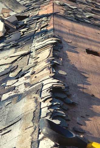 Damaged shingles and leaks showing sign that roof replacement is needed