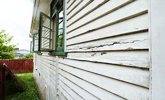 professional siding repair team working on residential home exterior